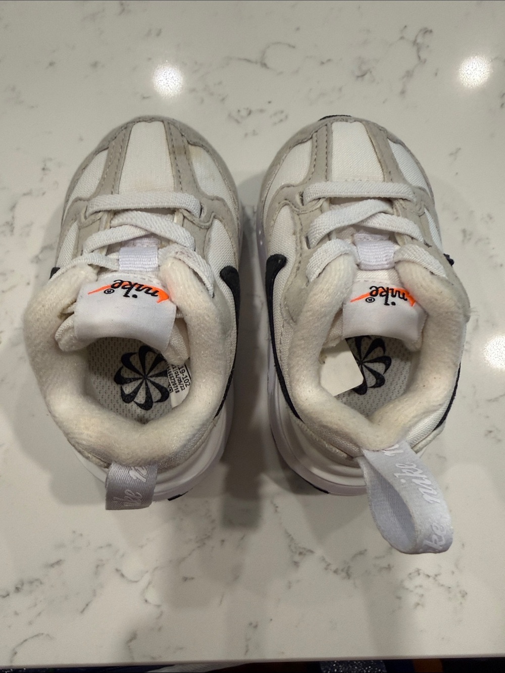 Nike Kids White Sneakers with Black Swoosh and Orange Accent